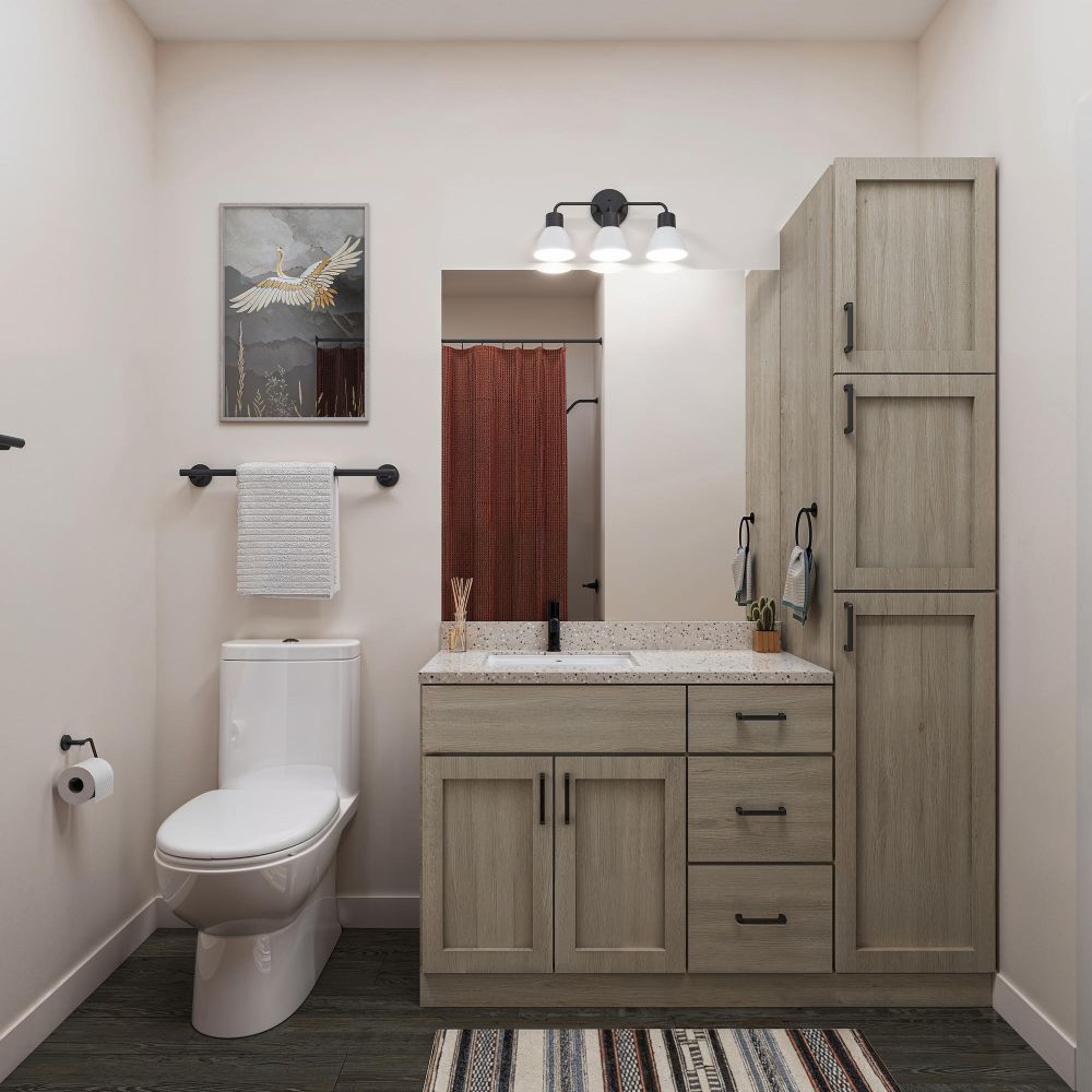 Modern bathroom with wooden vanity, toilet, wall art, striped rug, and neutral decor.