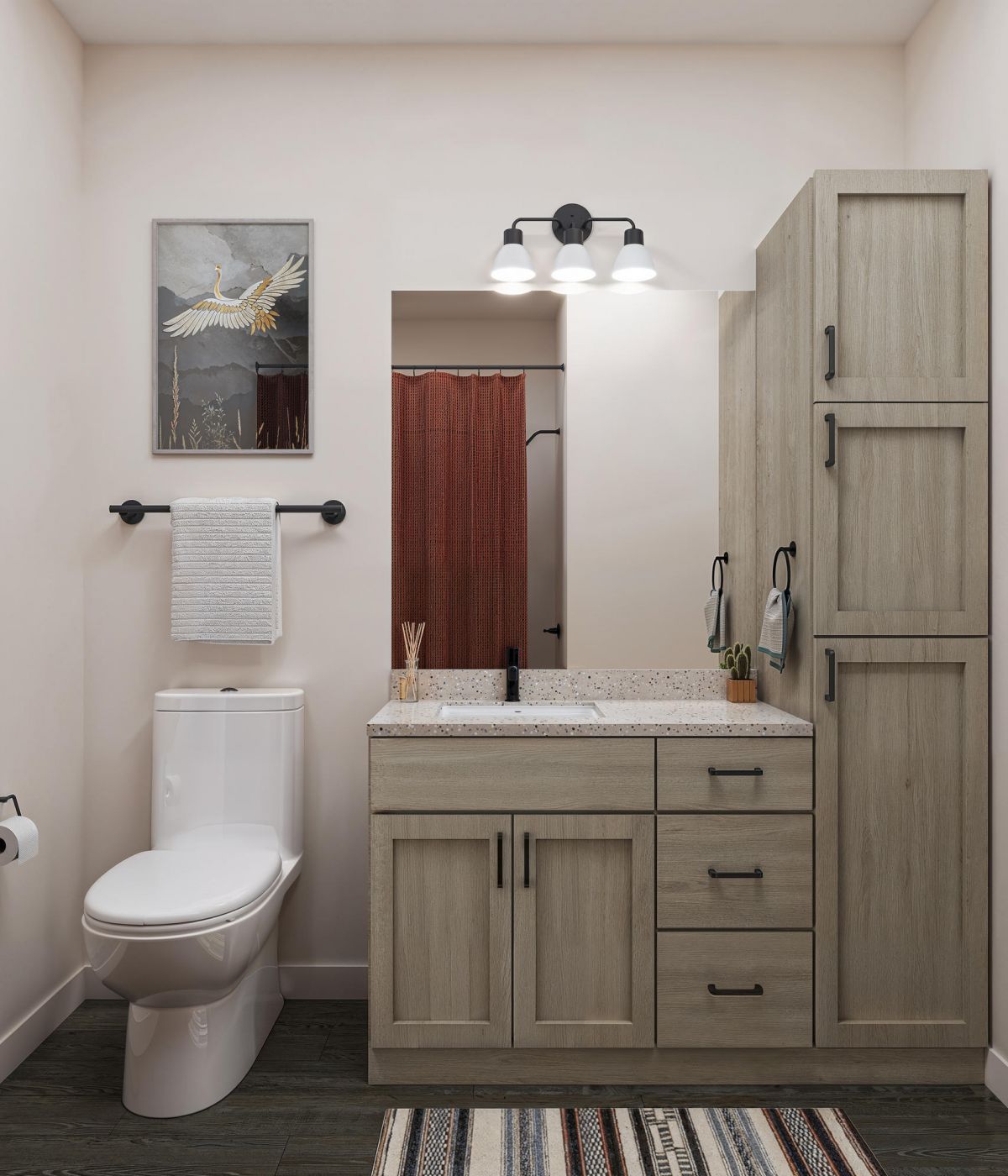 Modern bathroom with wooden vanity, toilet, wall art, striped rug, and neutral decor.