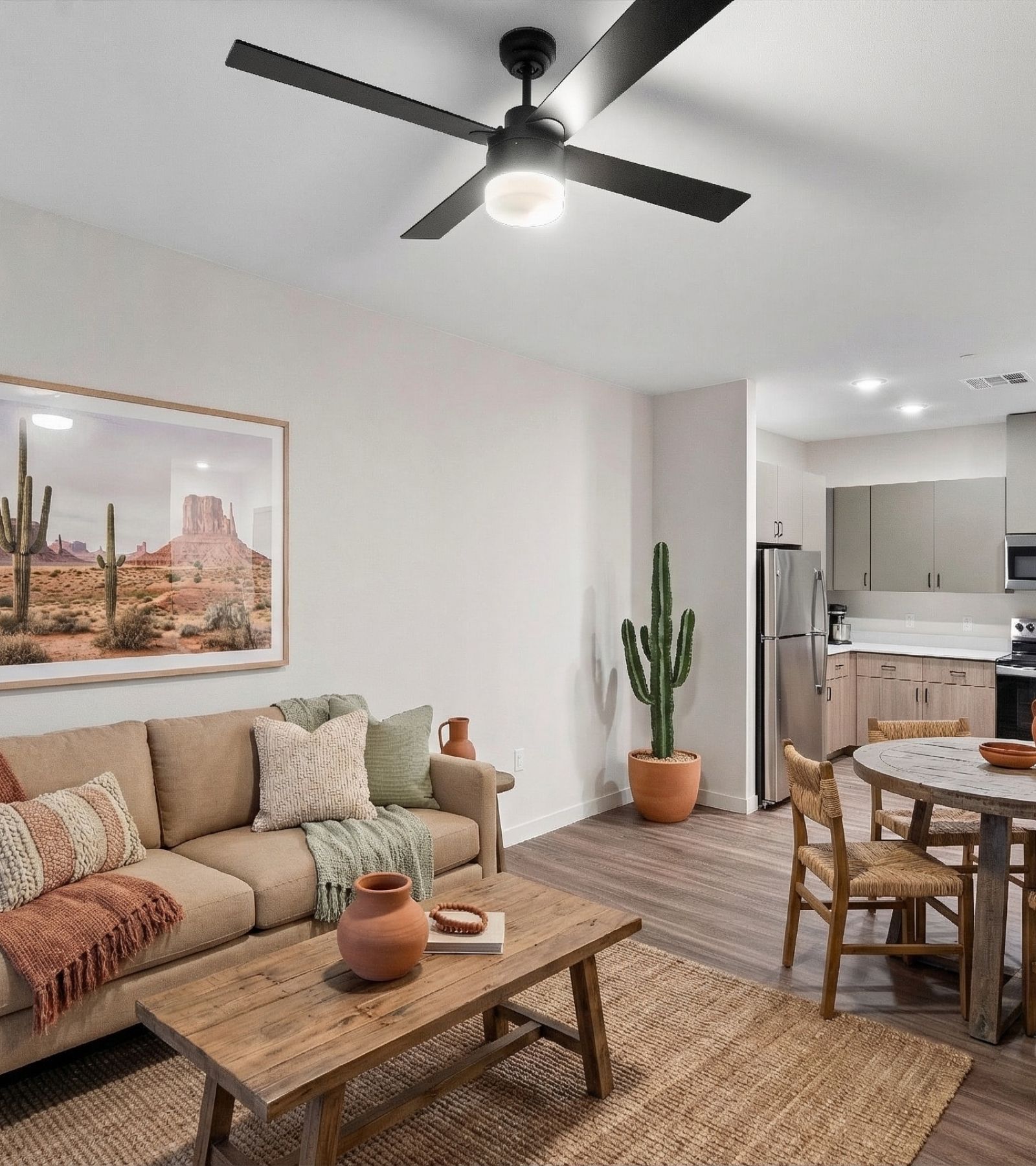 Open living and dining space in a Virata apartment with luxury vinyl plank flooring, a ceiling fan, and Southwestern decor